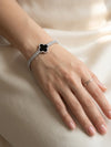 Silver clover tennis bracelet on wrist